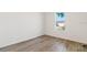 Bedroom featuring wood flooring and a window providing ample natural light and outside view at 18629 Coastal Shore Ter, Land O Lakes, FL 34638