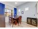 Elegant dining room with wood table, chairs, and large windows offering natural light at 18629 Coastal Shore Ter, Land O Lakes, FL 34638