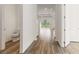 Bright hallway featuring wood flooring and a view to the living area with natural light at 18629 Coastal Shore Ter, Land O Lakes, FL 34638