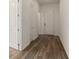 Clean hallway showcasing wood flooring and white doors for a modern, neutral aesthetic at 18629 Coastal Shore Ter, Land O Lakes, FL 34638