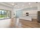 Bright, open-concept kitchen featuring stainless steel appliances, an island, and hardwood floors at 18629 Coastal Shore Ter, Land O Lakes, FL 34638