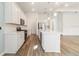 Contemporary kitchen featuring white cabinets, stainless steel appliances, and a large island at 18629 Coastal Shore Ter, Land O Lakes, FL 34638