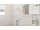 Practical laundry room with sink, open storage, and window offers convenience for everyday tasks at 18629 Coastal Shore Ter, Land O Lakes, FL 34638