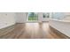 Spacious living room featuring hardwood floors, a sliding glass door and an open floor plan at 18629 Coastal Shore Ter, Land O Lakes, FL 34638