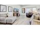 Spacious living room with ample seating, a media console, and a view of the outdoors at 18629 Coastal Shore Ter, Land O Lakes, FL 34638