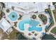 Aerial view of a resort-style pool area with multiple pools, lounge chairs, cabanas, and lush landscaping at 18629 Coastal Shore Ter, Land O Lakes, FL 34638