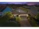 Aerial view of a beautiful home with a two car garage and a brick driveway, set against a serene backdrop at 19504 Lily Pond Ct, Brooksville, FL 34601