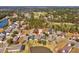Aerial view of the property with a manicured lawn, water feature, and a golf course in the distance at 19504 Lily Pond Ct, Brooksville, FL 34601