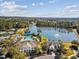Aerial view of the neighborhood amenities featuring a pool, clubhouse, and beautiful lake at 19504 Lily Pond Ct, Brooksville, FL 34601