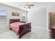 Spacious bedroom with neutral walls, tile floors, and natural light from windows at 19504 Lily Pond Ct, Brooksville, FL 34601
