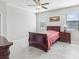 Cozy bedroom with tile floors, a ceiling fan, and natural light from the windows at 19504 Lily Pond Ct, Brooksville, FL 34601