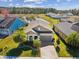 Beautiful single-story home with a brick driveway, lush landscaping, and tranquil water views at 19504 Lily Pond Ct, Brooksville, FL 34601