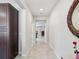 Bright hallway with tile flooring, leading to various rooms in the home at 19504 Lily Pond Ct, Brooksville, FL 34601