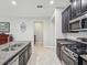 Kitchen features stainless steel appliances, granite counters, and an island with a sink at 19504 Lily Pond Ct, Brooksville, FL 34601