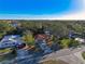 Charming single-story home with a red roof, mature trees, and a spacious driveway in a serene neighborhood at 5518 Pinehurst Dr, Spring Hill, FL 34606