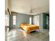 Inviting bedroom with tile floors, natural light, and built-in closet at 5518 Pinehurst Dr, Spring Hill, FL 34606