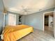 Relaxing bedroom featuring tile floors, a ceiling fan, and ample closet space at 5518 Pinehurst Dr, Spring Hill, FL 34606