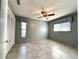 This bedroom is a canvas for personalization, featuring neutral walls and ceiling fan at 5518 Pinehurst Dr, Spring Hill, FL 34606