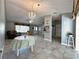 Bright living room featuring tile floors, large windows, and open layout to adjacent rooms at 5518 Pinehurst Dr, Spring Hill, FL 34606