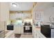 Cozy kitchen with white cabinetry, black appliances, and natural light at 6002 Laketree Ln # L, Temple Terrace, FL 33617