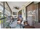Charming screened porch with comfortable seating and tropical accents at 6002 Laketree Ln # L, Temple Terrace, FL 33617