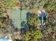 A view of the tennis courts in a mature shaded setting at 6002 Laketree Ln # L, Temple Terrace, FL 33617