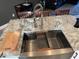 Spacious kitchen island with granite countertops, stainless steel sink, and built-in features at 6734 Dali Ave # 205, Land O Lakes, FL 34637