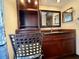 Bathroom with custom cabinets, granite counters, decorative mirror, and stylish decor at 7090 Red Oak Loop, New Port Richey, FL 34654