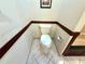 Clean bathroom with a standard toilet, wood trim, and tiled floor at 7090 Red Oak Loop, New Port Richey, FL 34654
