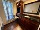 Bathroom with custom vanity, granite countertop, lots of cabinets, and a built-in make up area at 7090 Red Oak Loop, New Port Richey, FL 34654