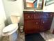 Bathroom featuring vanity with storage, a toilet, a decorative trash can, and unique wall mirror at 7090 Red Oak Loop, New Port Richey, FL 34654