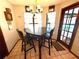 Cozy breakfast nook with seating for four, tiled floor, and a view of the pool area at 7090 Red Oak Loop, New Port Richey, FL 34654