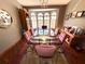 Dining room with a glass table, seating for six, and large windows with natural light at 7090 Red Oak Loop, New Port Richey, FL 34654