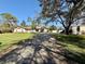 Sprawling single-story home featuring a large driveway and well-manicured lawn at 7090 Red Oak Loop, New Port Richey, FL 34654