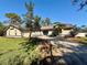 Well-kept lawn and a welcoming exterior with a long driveway, perfect for parking at 7090 Red Oak Loop, New Port Richey, FL 34654
