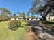 Charming single-story home boasts a lush lawn and long driveway leading to the attached garage at 7090 Red Oak Loop, New Port Richey, FL 34654