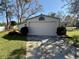Detached garage on a sunny day with a well-maintained lawn at 7090 Red Oak Loop, New Port Richey, FL 34654