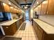 Spacious kitchen featuring tile floors, light countertops, and wooden cabinets at 7090 Red Oak Loop, New Port Richey, FL 34654