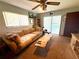 Comfortable living room featuring a plush sofa, unique wood coffee table, and sliding door access to pool at 7090 Red Oak Loop, New Port Richey, FL 34654