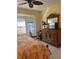 Bright bedroom featuring a ceiling fan, large dresser, and a bay window with natural light at 7219 Cleopatra Dr, Land O Lakes, FL 34637