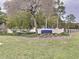 Beacon Woods East community entrance sign with well-maintained landscaping and a wrought iron fence at 8447 Pavilion Dr, Hudson, FL 34667