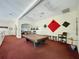 Spacious game room with a pool table, seating, and colorful wall decor at 8447 Pavilion Dr, Hudson, FL 34667