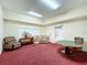 Cozy game room featuring comfortable seating, a poker table, and bright lighting at 8447 Pavilion Dr, Hudson, FL 34667