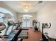 Bright gym featuring several exercise machines, a ceiling fan, and light-colored walls at 8447 Pavilion Dr, Hudson, FL 34667