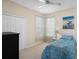Bright bedroom with a ceiling fan and views from two windows at 9819 Bridgeton Dr, Tampa, FL 33626