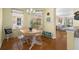 Bright dining area with a wooden table set and natural light from the adjacent windows at 9819 Bridgeton Dr, Tampa, FL 33626
