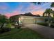 Charming home featuring a well-manicured lawn, mature landscaping, and a two-car garage at 9819 Bridgeton Dr, Tampa, FL 33626