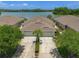 Aerial view of home featuring an oversized driveway and tranquil lake views at 9819 Bridgeton Dr, Tampa, FL 33626