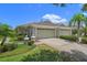 Charming home featuring a well-manicured lawn, mature landscaping, and a two-car garage at 9819 Bridgeton Dr, Tampa, FL 33626