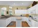 Well-lit kitchen with white cabinets, essential appliances, and views to the breakfast nook at 9819 Bridgeton Dr, Tampa, FL 33626